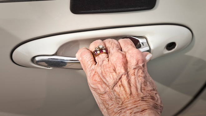 elderly_womans_hand_opening_car_door