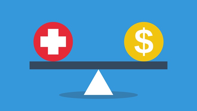 health and money symbols balanced on a scale