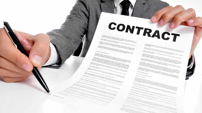 man holding pen and contract