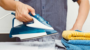 man using iron to do ironing