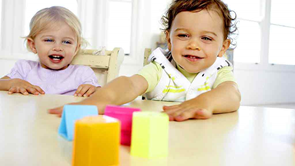 toddlers playing with coloured blocks