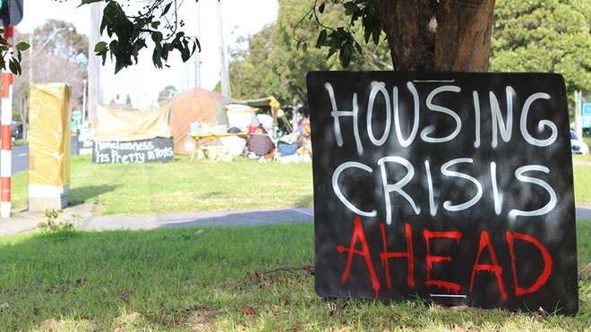 housing crisis ahead sign at the camp