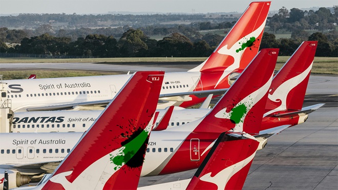 green paint splashes on tails of qantas planes