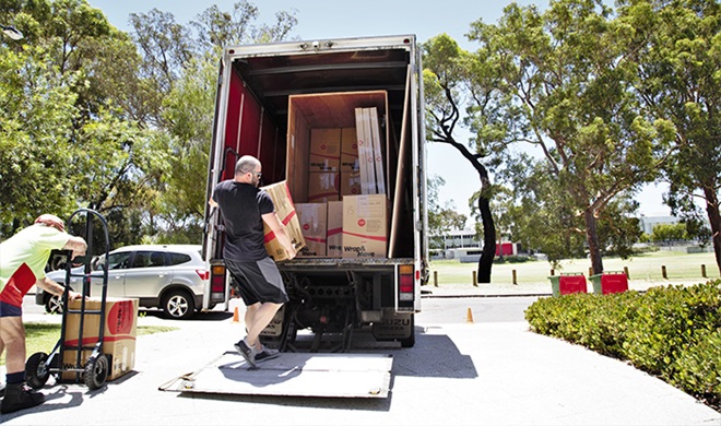 packing boxes into a moving van in perth