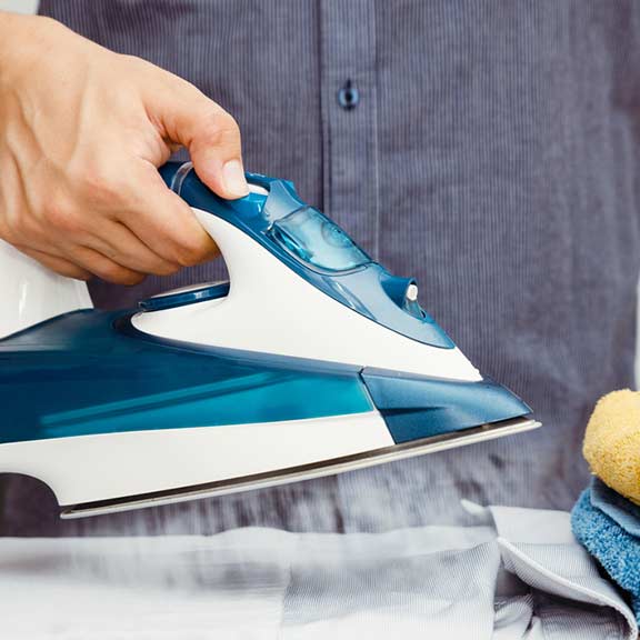 man using iron to do ironing sq