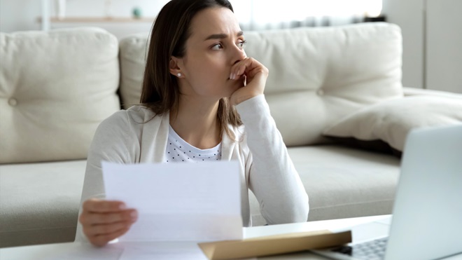 woman looking worried about money