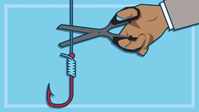 hand with scissors cutting a fishing line with hook