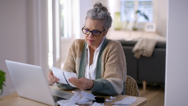 older_woman_looking_at_superannuation_death_benefits_documents