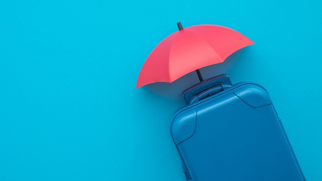 suitcase with umbrella covering it