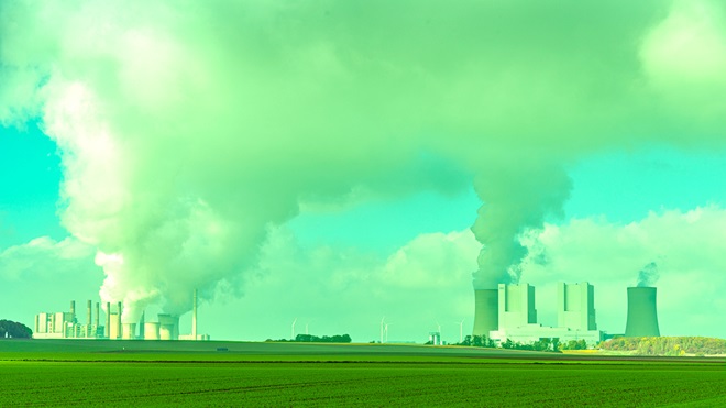 coal power plant billowing smoke tinted green