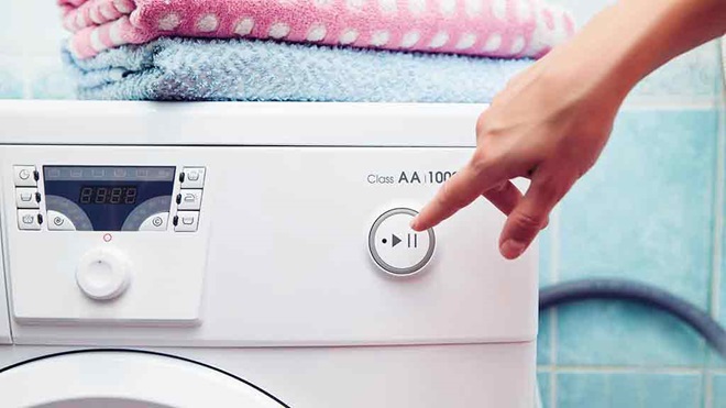 Man wipes trousers in the washing machine, Stock image