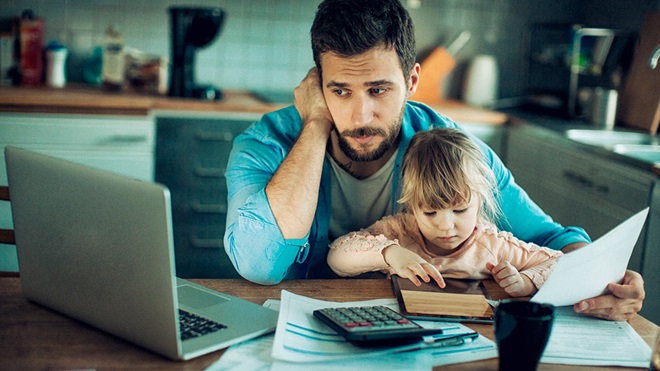 young father stressed at computer superannuation and life insurance