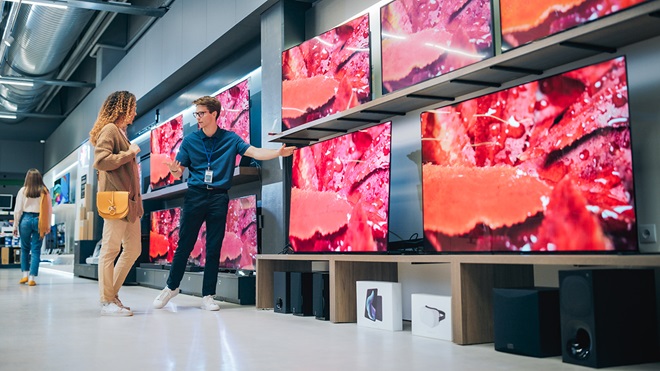 salesperson_showing_televisions_to_customer_in_store