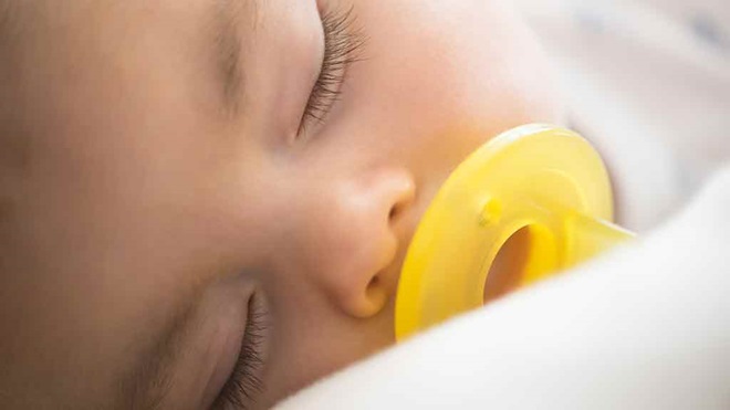 baby asleep with dummy in mouth