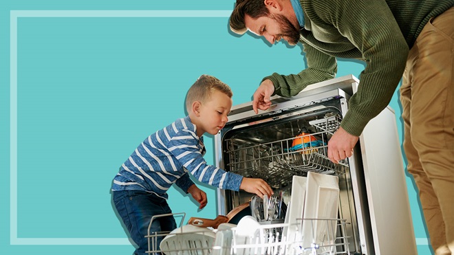 father and son loading a dishwasher