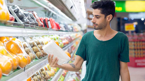 man checking product label in supermarket