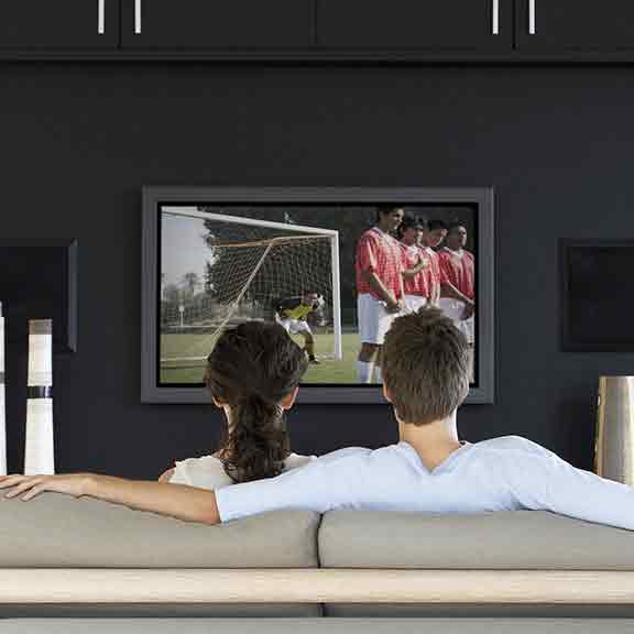 man and woman watch soccer on tv square