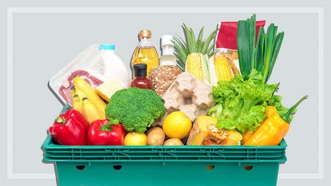 groceries in a green crate shown on a grey background