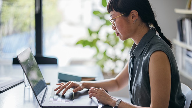 person_in_an_office_looking_a_laptop