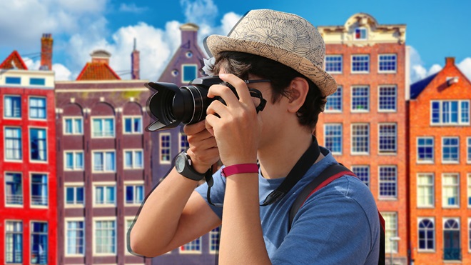 young man takes a photo in Amsterdam
