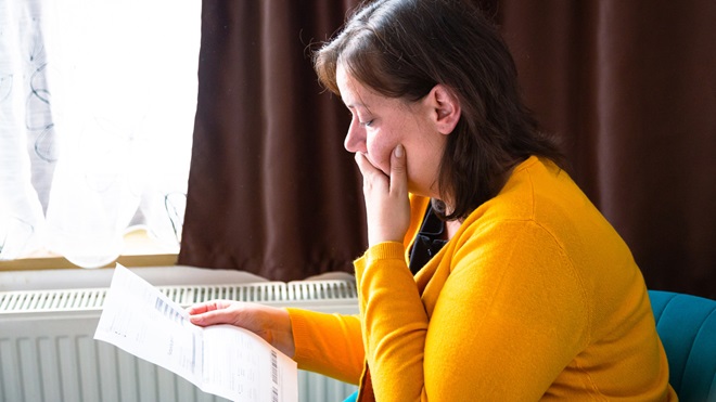 woman looking at energy bill winter
