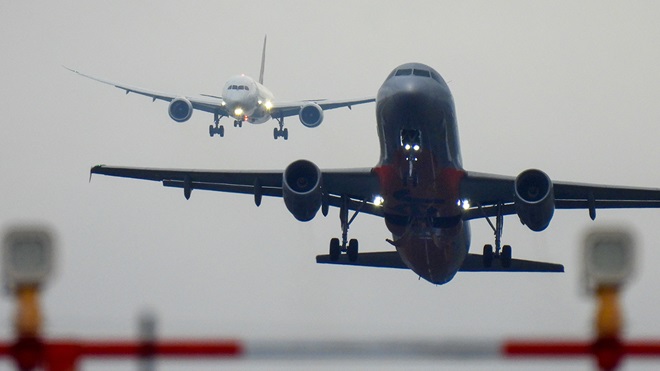 jetstar plane taking off in the foreground qantas plane landing in the background